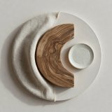Circular material study showing linen, timber and a ceramic sample